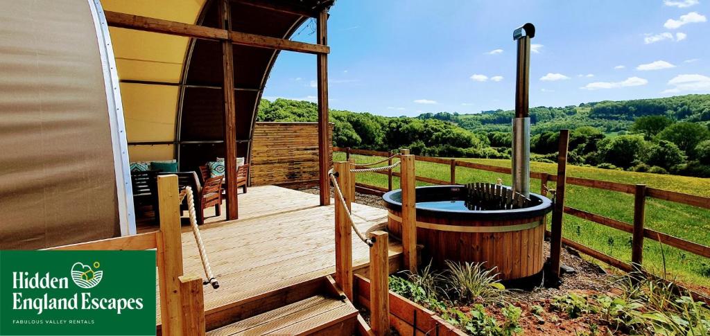 a deck with a hot tub and a gazebo at Huggeley Hall - Astounding, Chic, Valley Experience with Hot Tub in Stanford on Teme