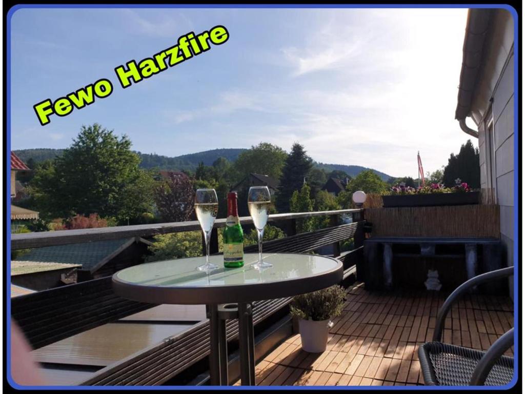 a table with two glasses of wine on a balcony at NEU! FeWo Harzfire mit Kamin in Bad Harzburg