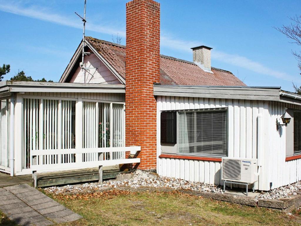 a white house with a bench in front of it at 6 person holiday home in Hemmet in Hemmet