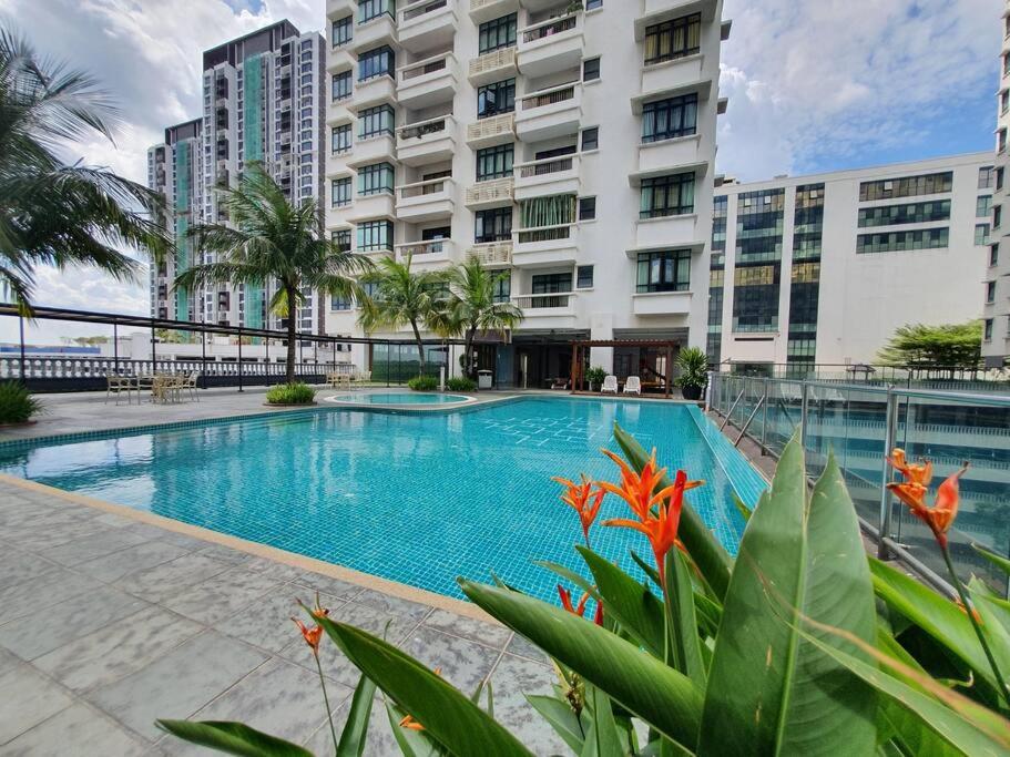 a large swimming pool in front of a building at Heritage 12 Homestay Studio 4Pax Free WIFI Netflix in Seri Kembangan