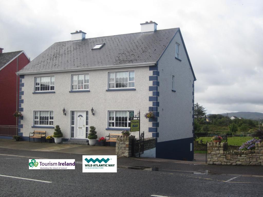 a white and blue house with a blue roof at Marguerite's B&B in Glenties