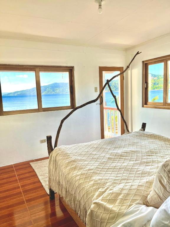 a bedroom with a bed with a view of the ocean at VILLA NEYRA 