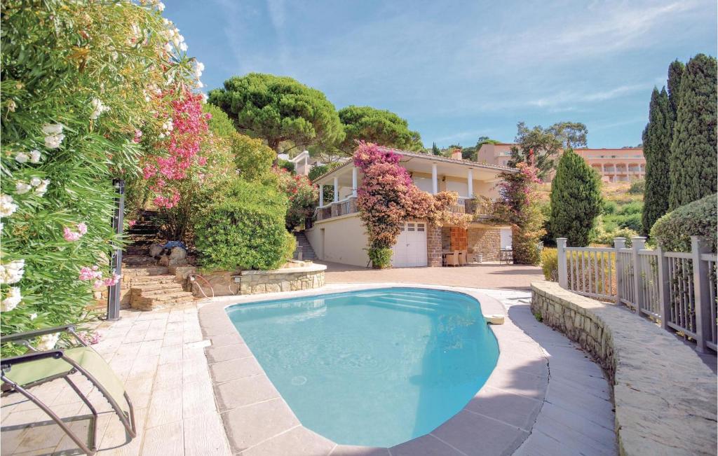 a swimming pool in the yard of a house at Nice Home In Rayol-canadel-sur-mer With 2 Bedrooms, Wifi And Outdoor Swimming Pool in Rayol-Canadel-sur-Mer