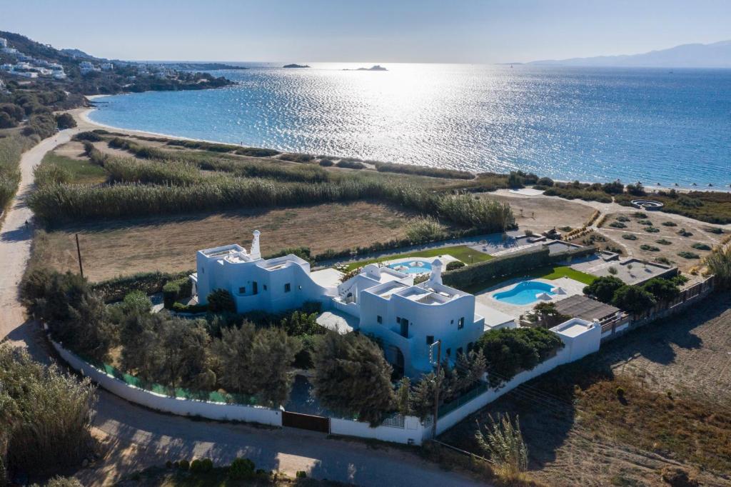 an aerial view of a house next to the ocean at Aqua Breeze Villas on the beach in Plaka