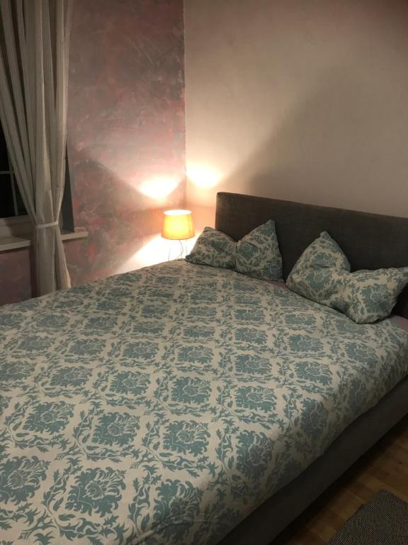 Schlafzimmer mit einem Bett mit einer blauen und weißen Bettdecke in der Unterkunft Large double room next to Elisabeth Line in Abbey Wood