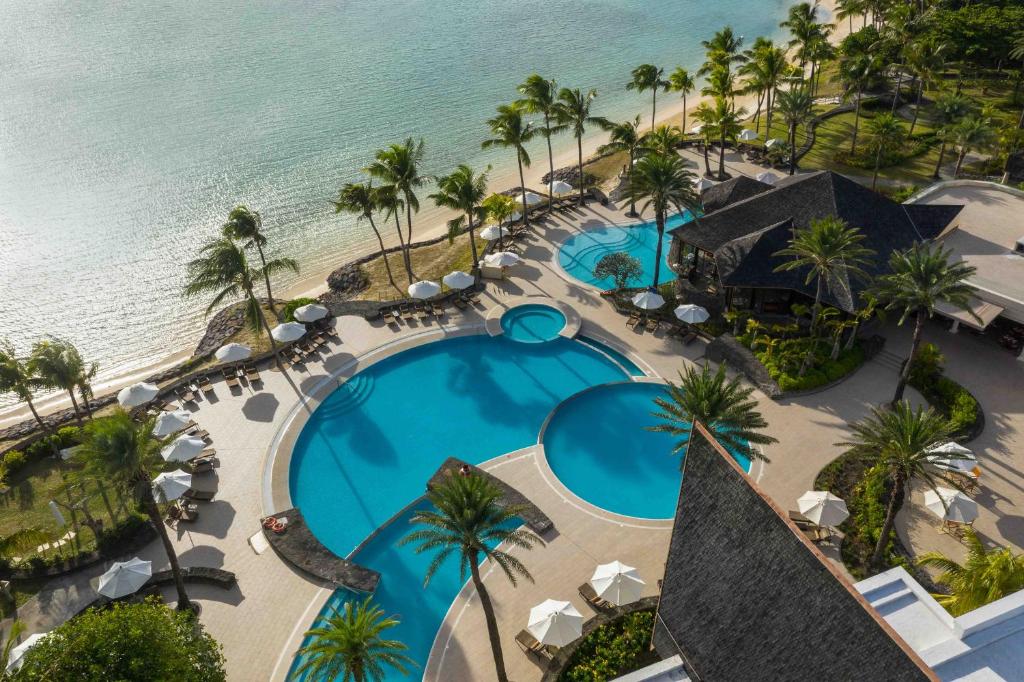 an overhead view of the pool and beach at the resort at The Residence Mauritius in Belle Mare