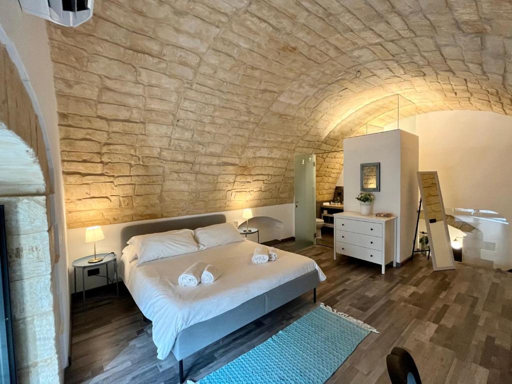 Krevet ili kreveti u jedinici u okviru objekta Dammusu Marchesi di Sant' Elia, patrimonio UNESCO