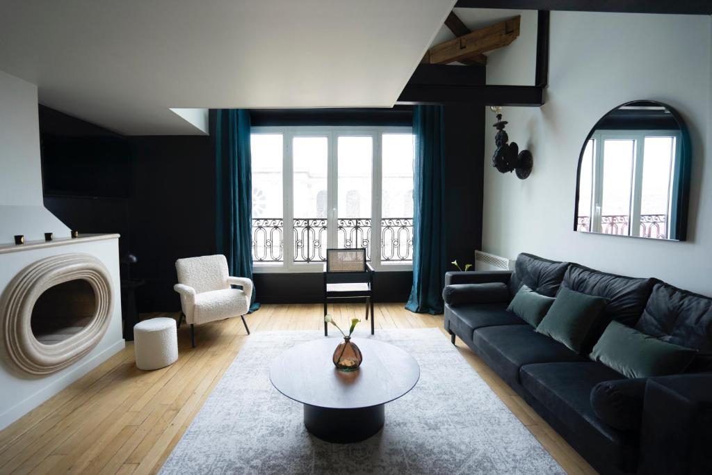 a living room with a couch and a table at Mithouard Apartments in Paris