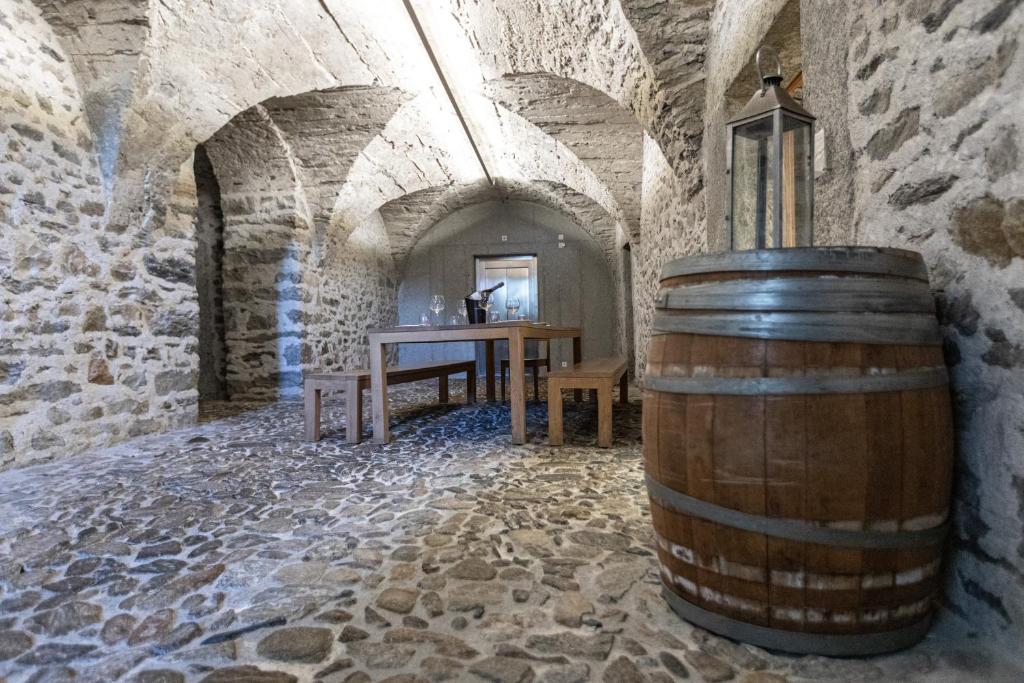 a wine barrel in a room with a table at Hotel Restaurant Stockalperturm in Ruden