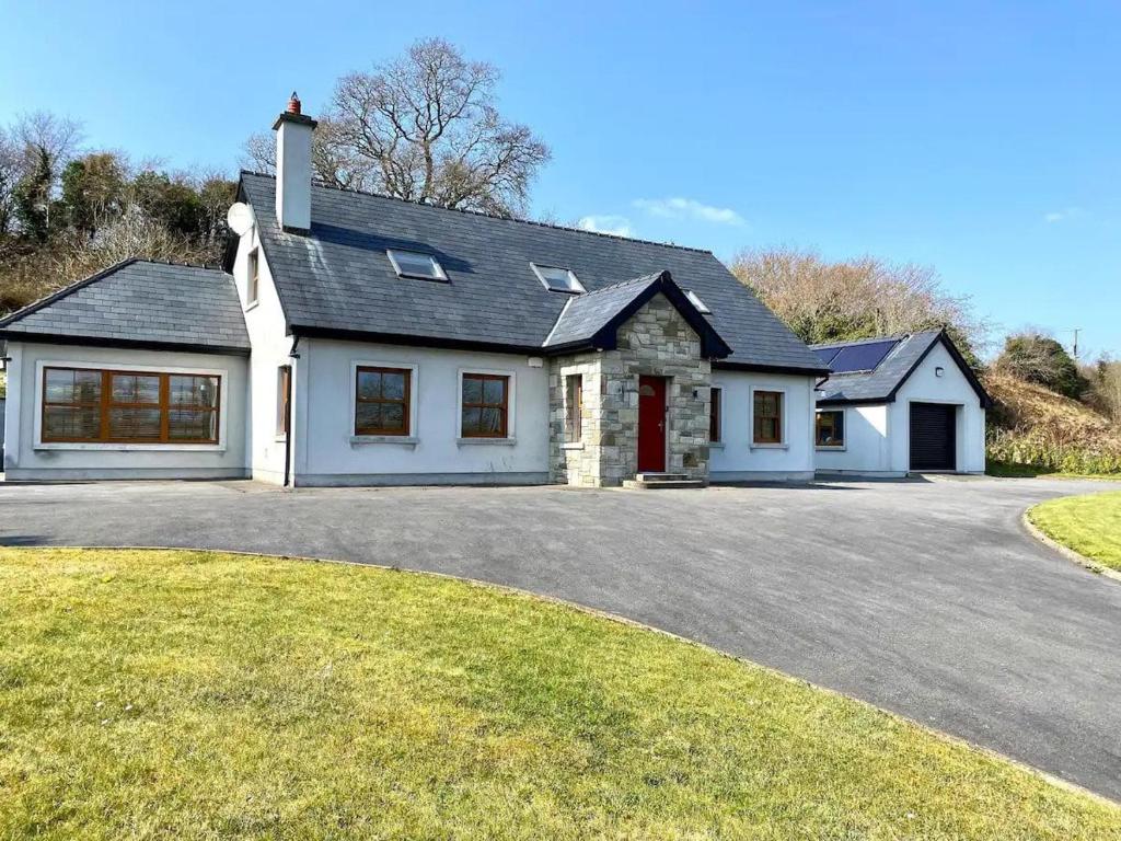 a large white house with a driveway at Ballydonnellan in Westport