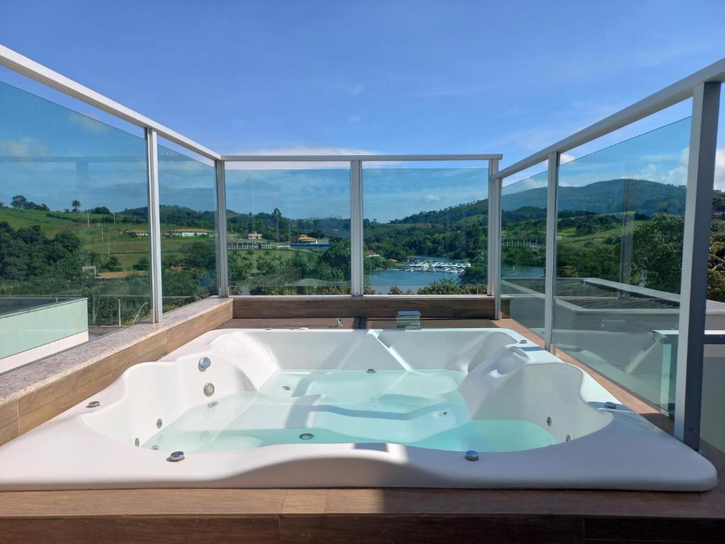 a bath tub in the middle of a room with windows at Casa Capitolio in Capitólio