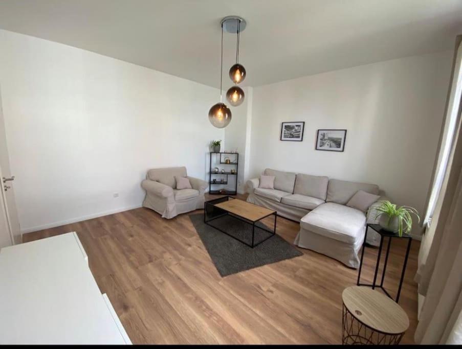 a living room with a couch and a table at Südstrand nahe Eigentumswohnung mit Stil in Wilhelmshaven