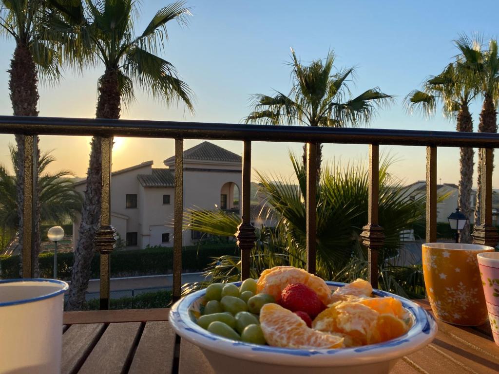 a bowl of fruit on a table on a balcony at Sonne - Golf - 4Pers. - Apartments in Fuente-Álamo de Murcia