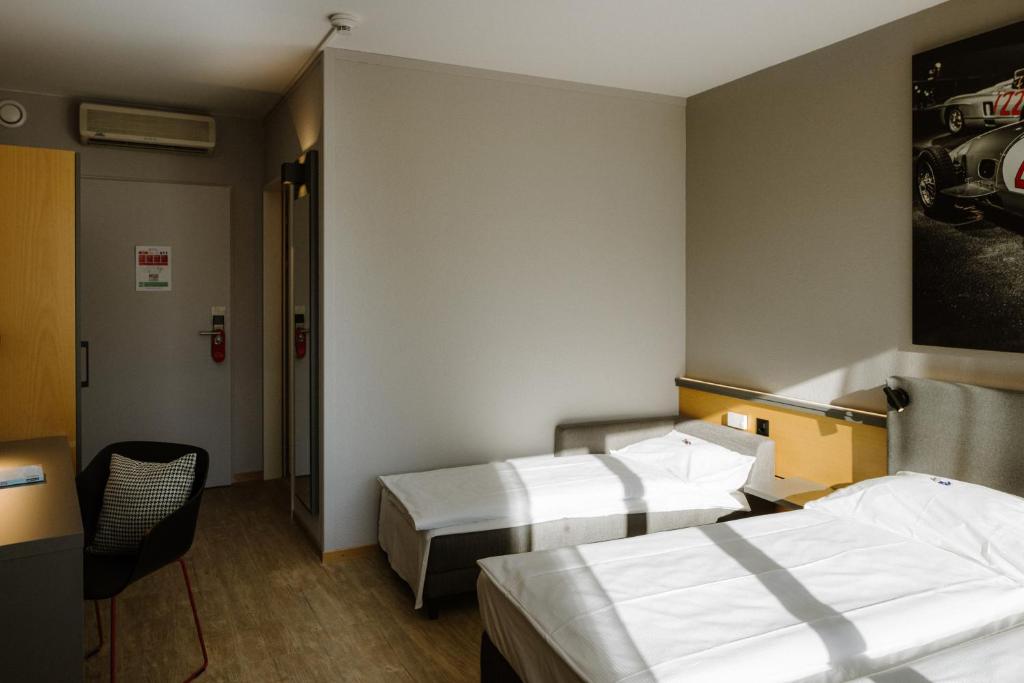 Postel nebo postele na pokoji v ubytování Hotel A1 Grauholz
