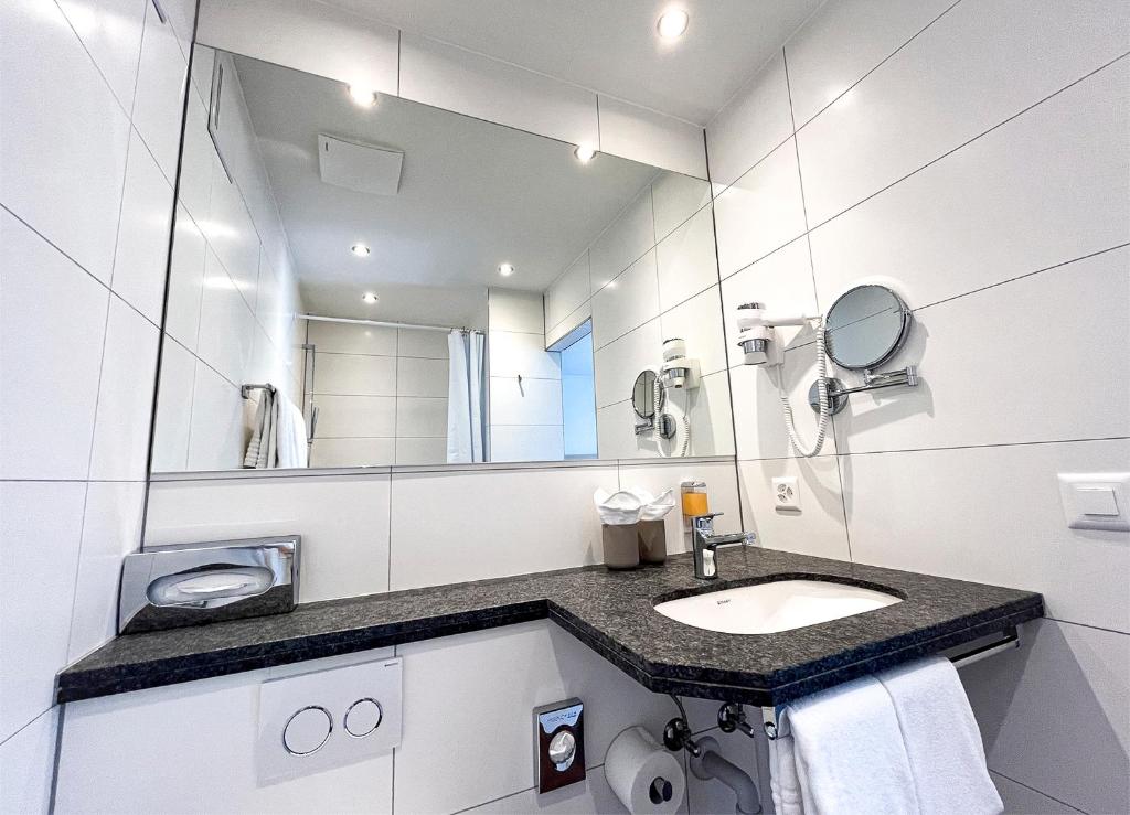 a bathroom with a sink and a mirror at Gasthaus zur Waldegg in Luzern