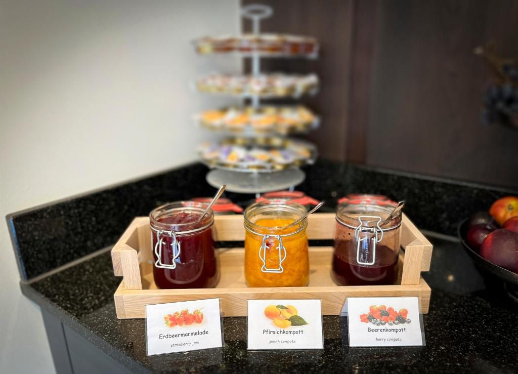 a table with jars of jam and a cake at Gasthaus zur Waldegg in Luzern