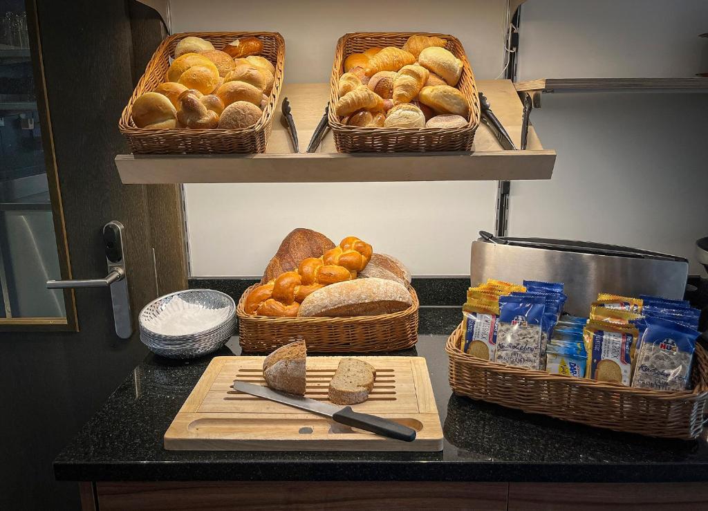 a counter top with baskets of bread and baskets of bread at Gasthaus zur Waldegg in Luzern