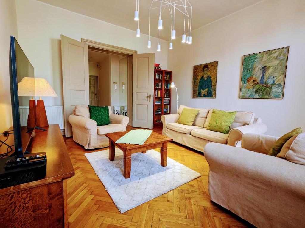 a living room with two couches and a table at Apartament Bryza przy molo, parku i placu zabaw in Sopot