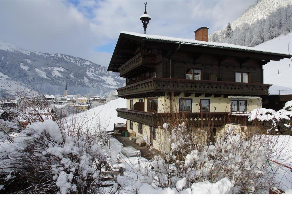 a large wooden house with snow on the ground at Feldinggut in Bad Hofgastein