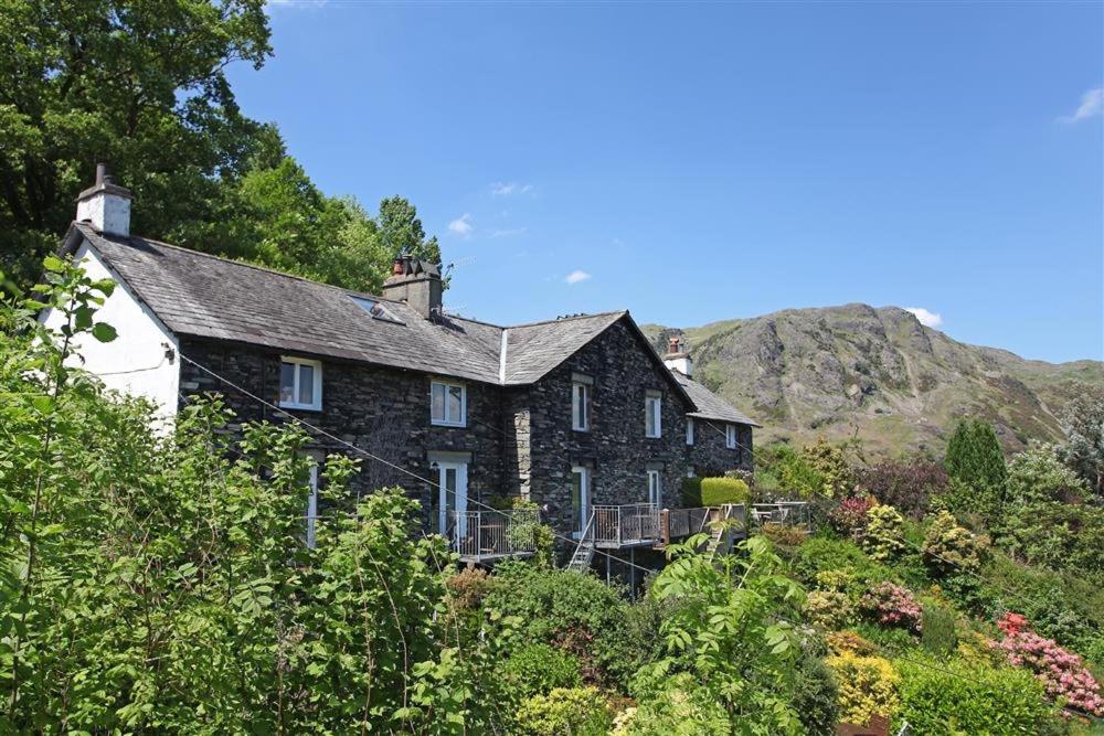 an old house in the middle of a hill at Bank Top Cottage Coniston in Coniston