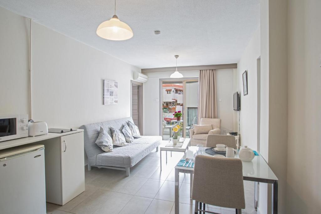 a living room with a couch and a table at Ayia Napa Holiday Apartment So3 in Ayia Napa