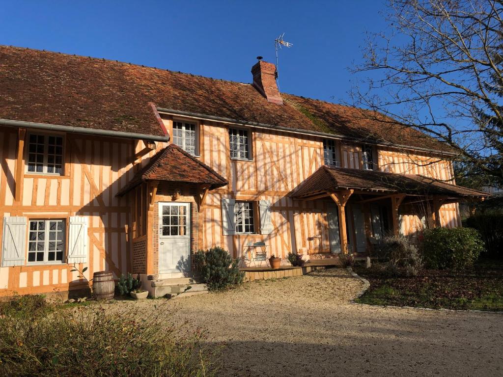 a large wooden house with a roof at La Coraline in Laubressel