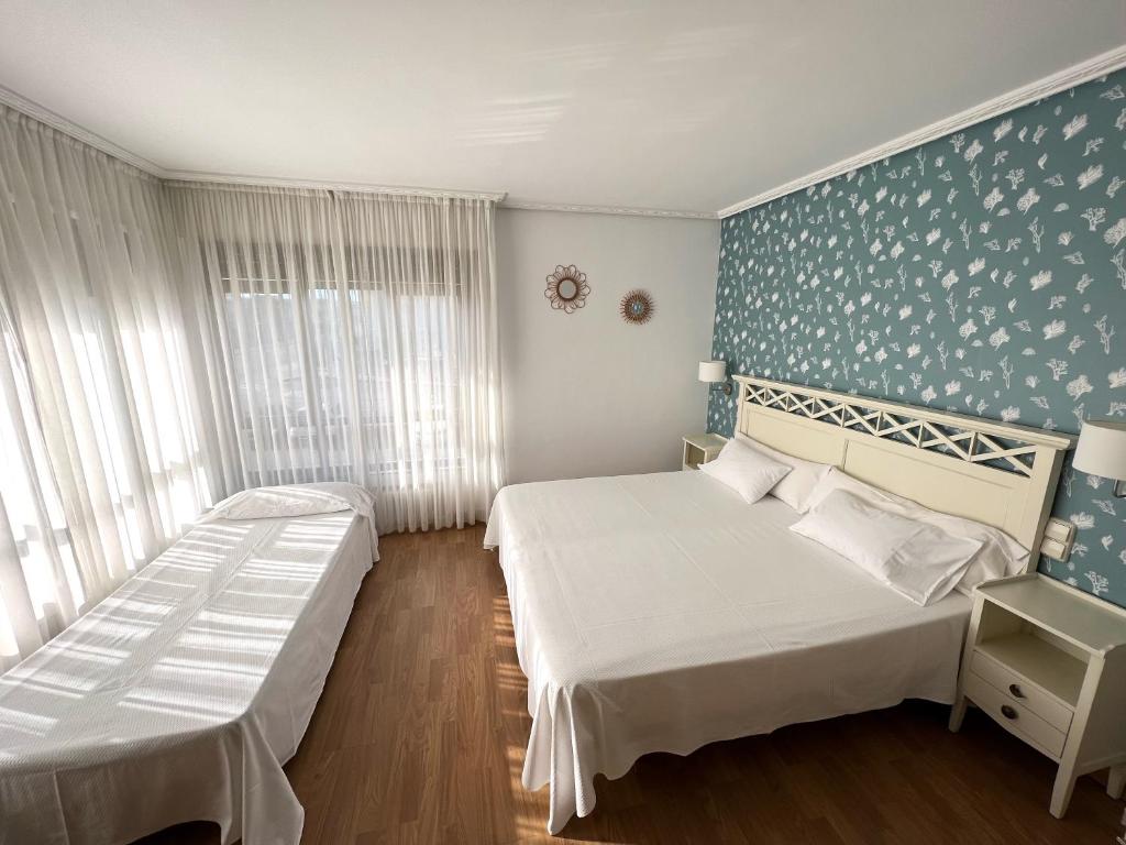 A bed or beds in a room at Hotel Playa de Los Locos