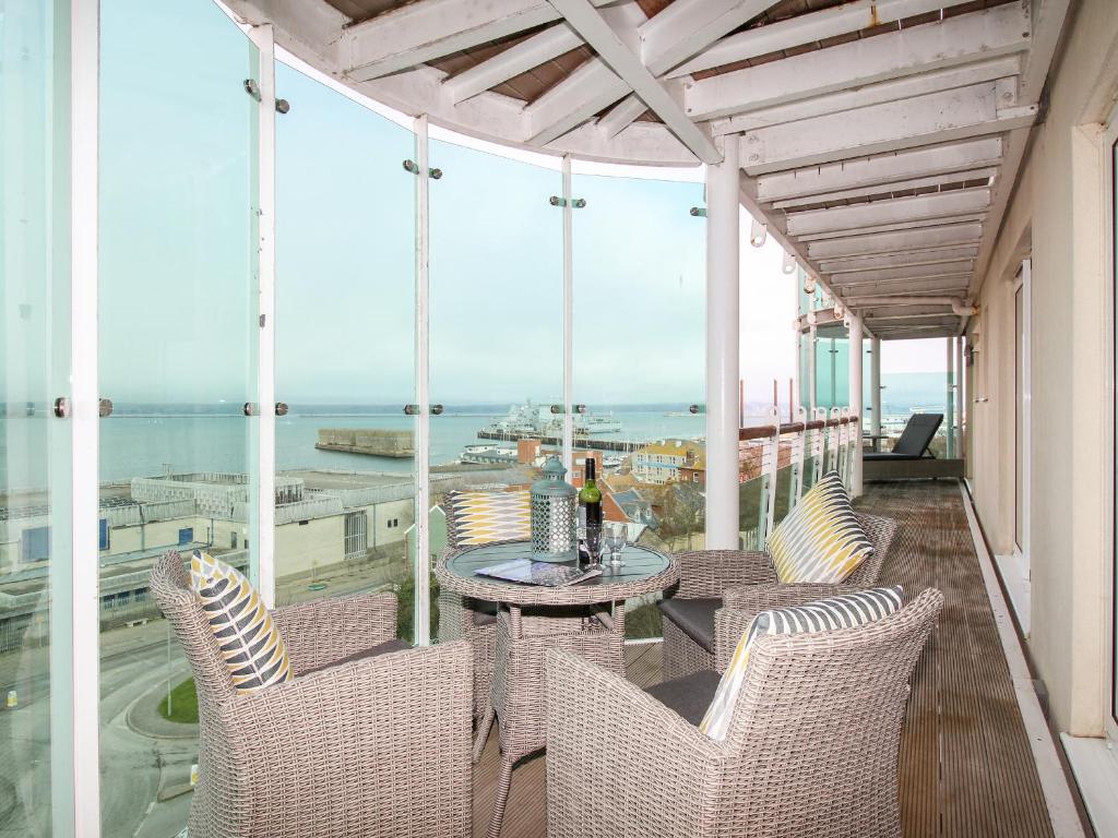 a balcony with chairs and a table with a view of the ocean at Bear's Apartment in Portland