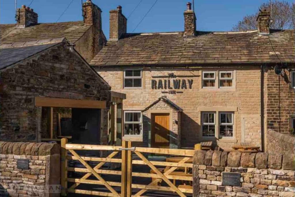 an old building with a wooden gate in front of it at 2 Bedroom apartment, Cononley near Skipton in Cononley