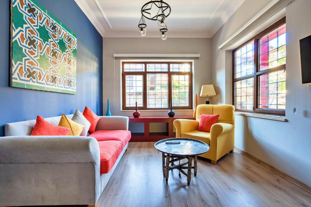 a living room with a couch and two chairs and a table at Fascinating Flat near Hadrians Gate in Antalya