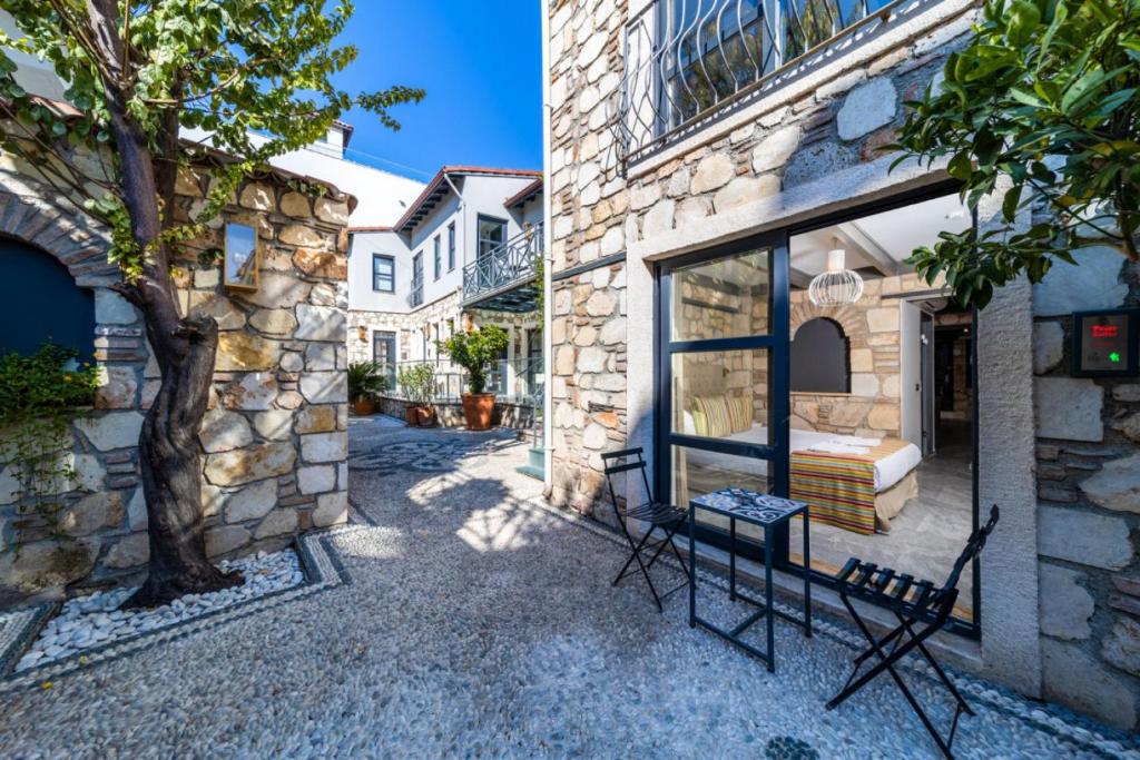 a stone building with two chairs outside of it at Charming Flat near Hadrians Gate in Antalya