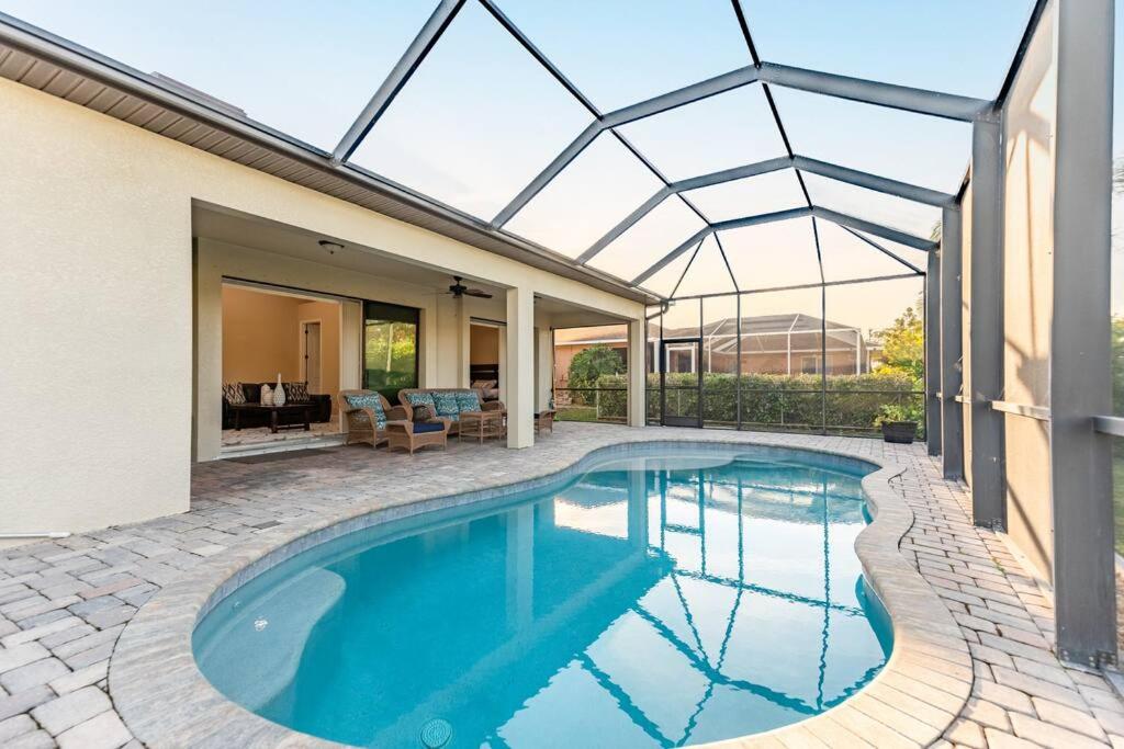 a swimming pool in a house with a glass roof at Villa -natalia in Cape Coral