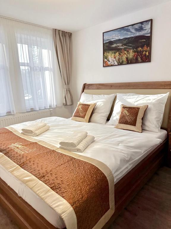 Postel nebo postele na pokoji v ubytování SYNEK Pension