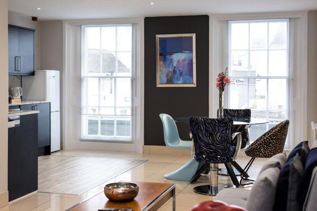 a living room with a table and chairs at Hairbnb - stylish and central in Eastbourne
