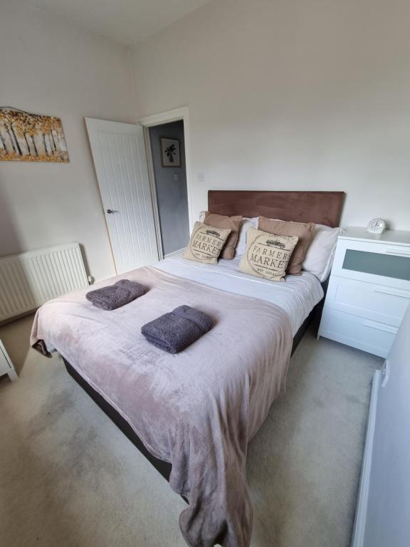 ein Schlafzimmer mit einem großen Bett mit zwei Kissen darauf in der Unterkunft Cottage 5 minutes walk to river and town centre in Stratford-upon-Avon