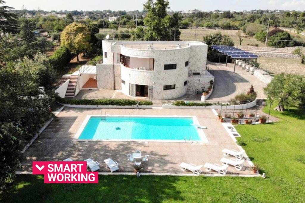 an aerial view of a house with a swimming pool at Villa Montedoro Luxury in Noci