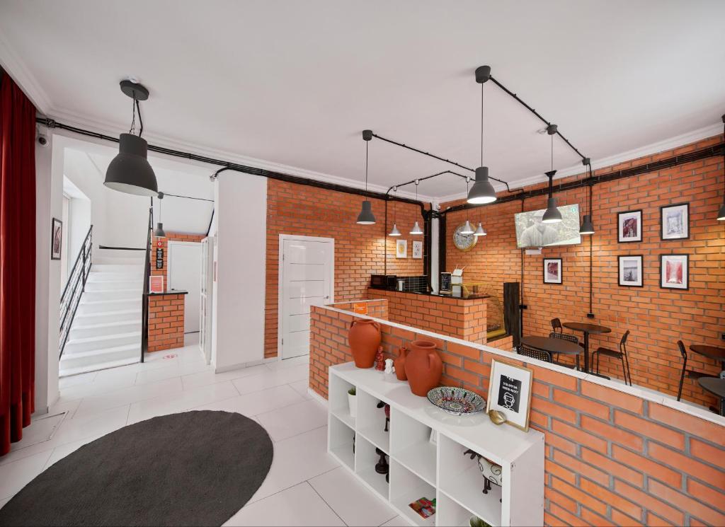 a living room with a brick wall and a table at HELLO INN budget hotel in Astana