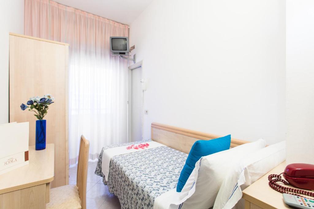 Postel nebo postele na pokoji v ubytování Hotel Cola Frontemare