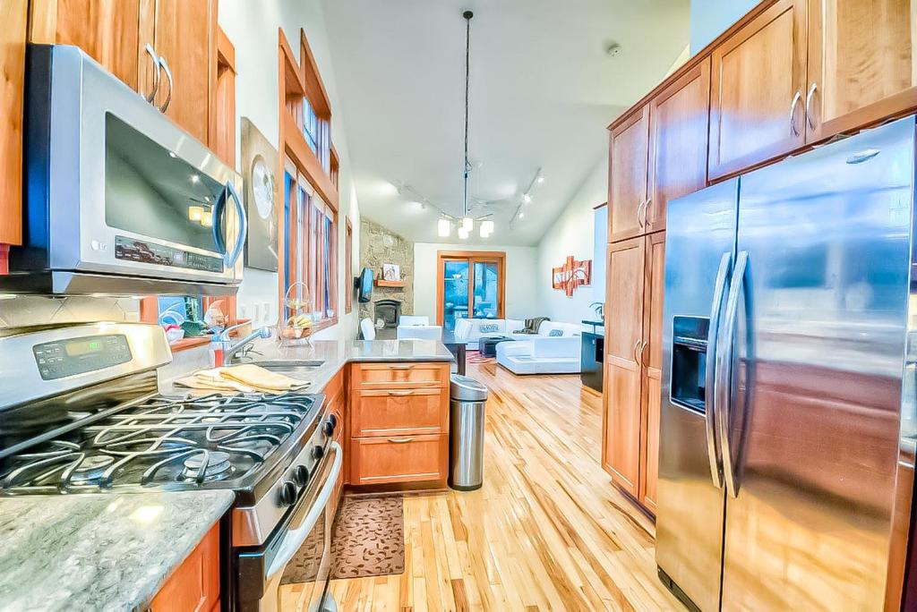 a kitchen with wooden cabinets and a stove top oven at Villa BG in Steamboat Springs