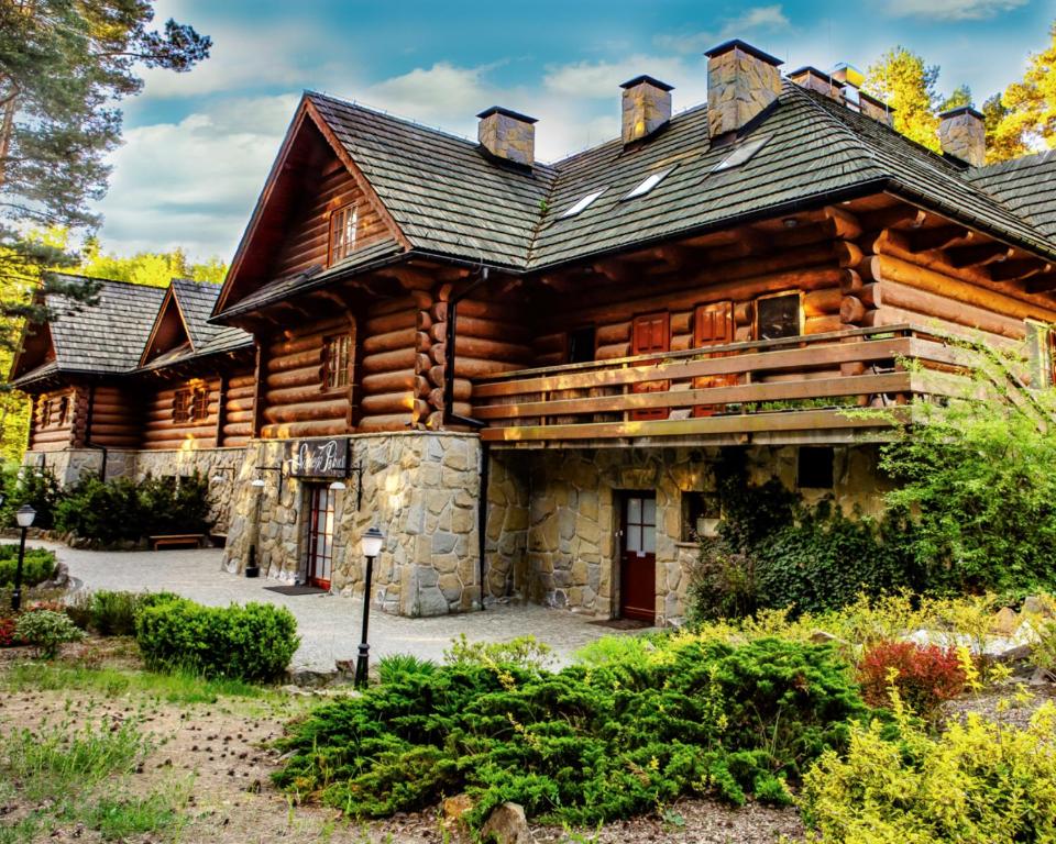 a log cabin with a gambrel roof at Hotel 365 in Kielce