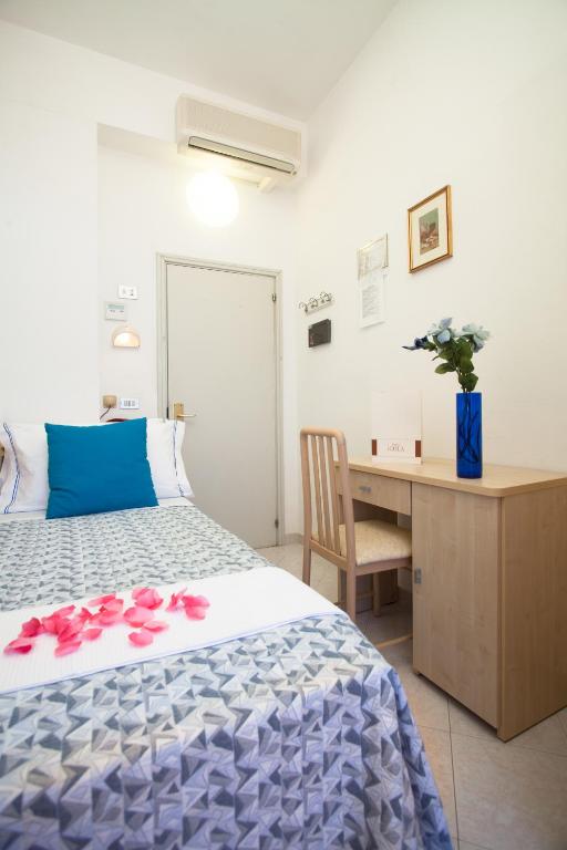 Postel nebo postele na pokoji v ubytování Hotel Cola Frontemare
