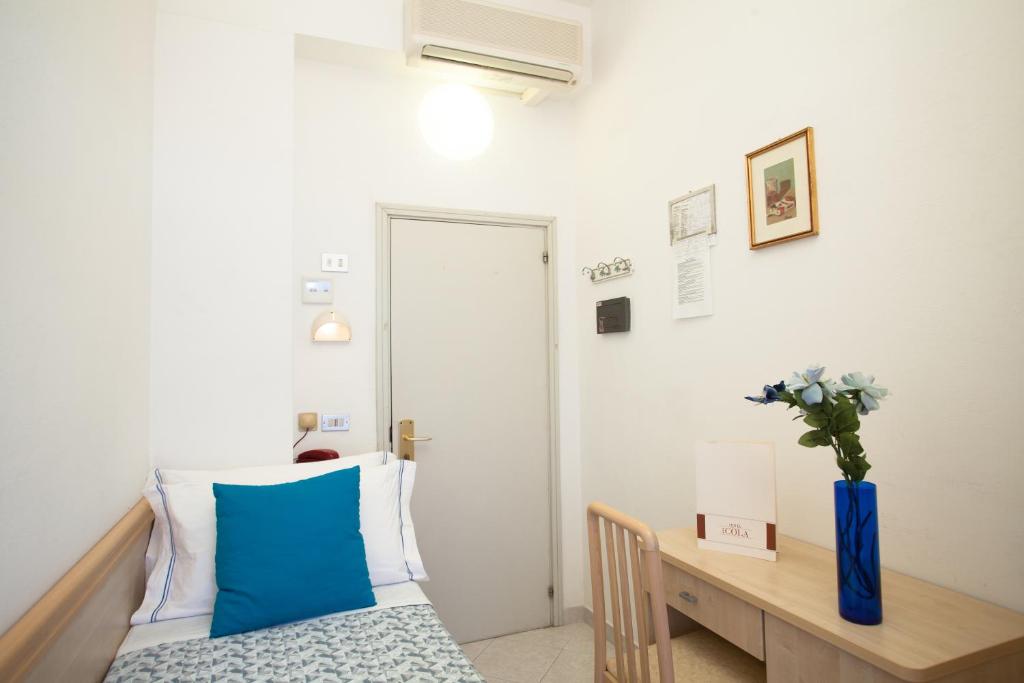 Postel nebo postele na pokoji v ubytování Hotel Cola Frontemare