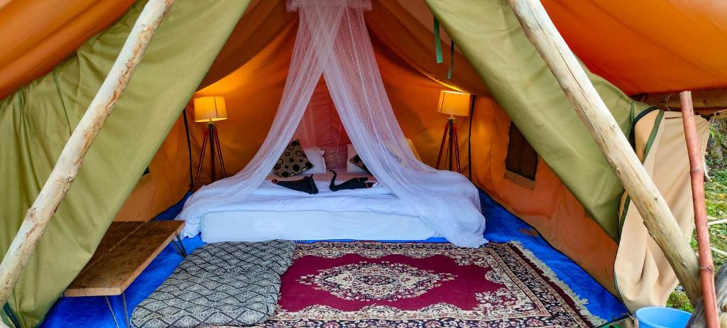 a bedroom in a tent with a bed in it at Neerville Waterfall Glamping- Neer waterfall in Shivpuri