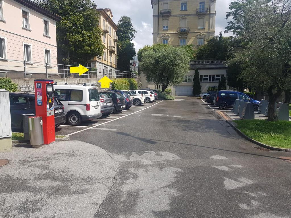 une rue vide avec des voitures garées dans un parking dans l'établissement Central Lugano Family Flat 2 Bedrooms Lake view, à Lugano