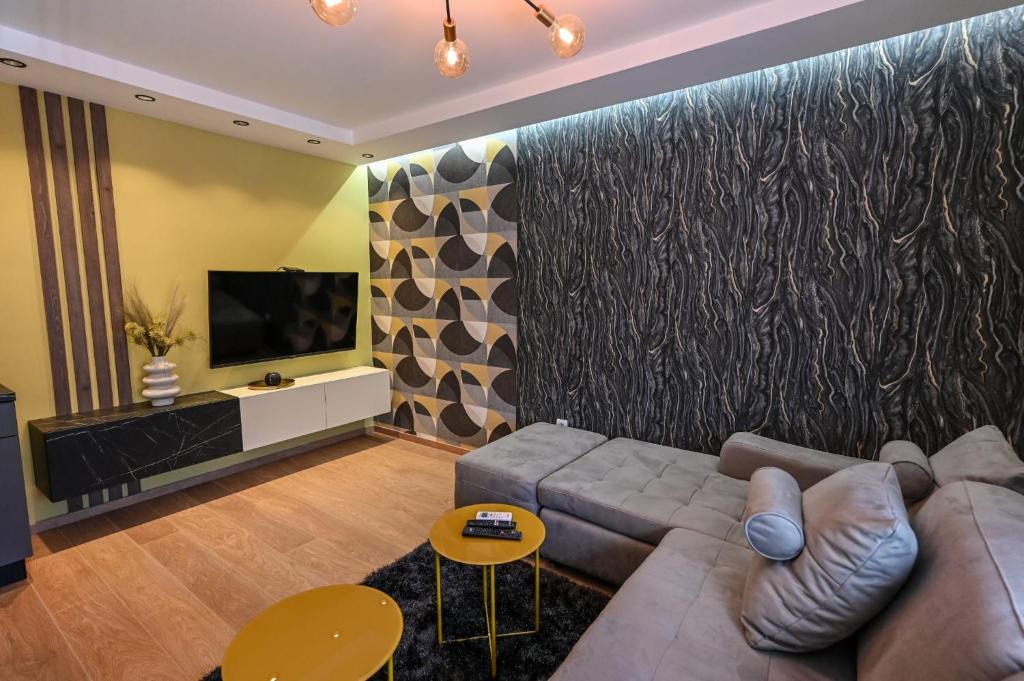 a living room with a couch and a flat screen tv at BANE APARTMANI 7 in Kraljevo