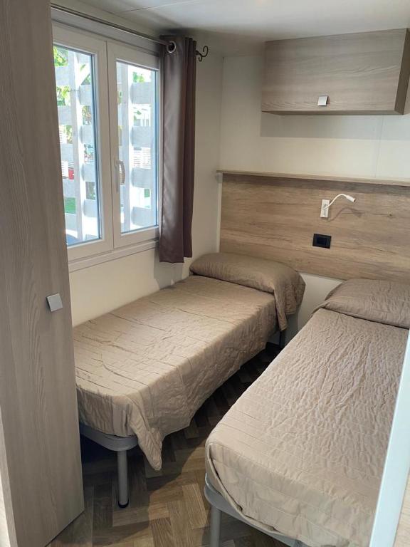 A bed or beds in a room at Camping Adriatico