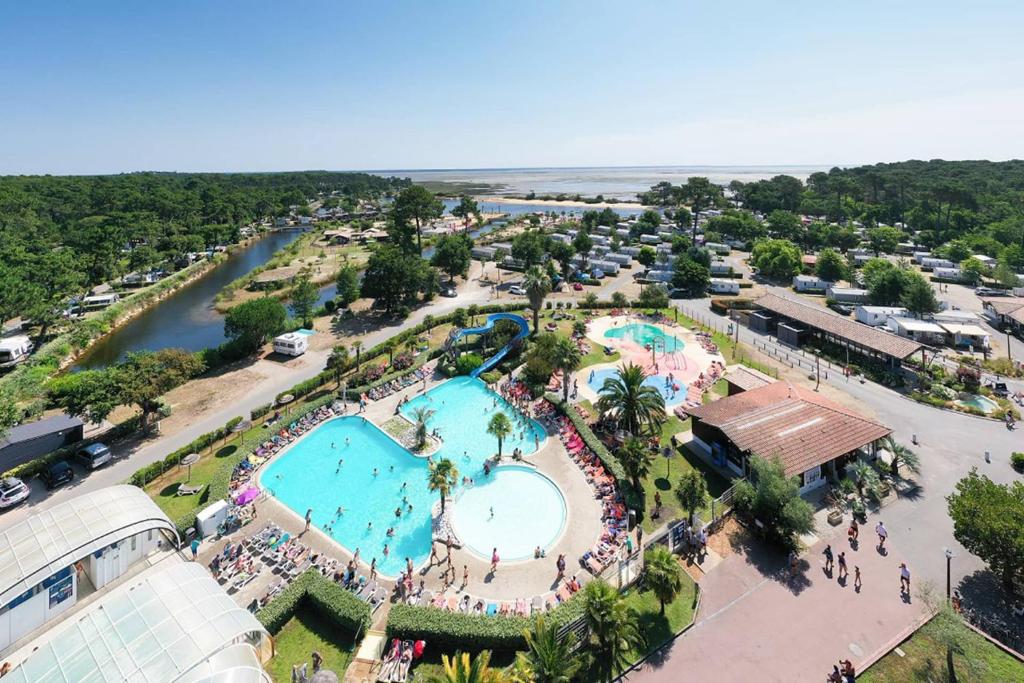 an aerial view of a pool at a resort at Chris et Sabrina - Camping Les Viviers 4 étoiles in Lège-Cap-Ferret