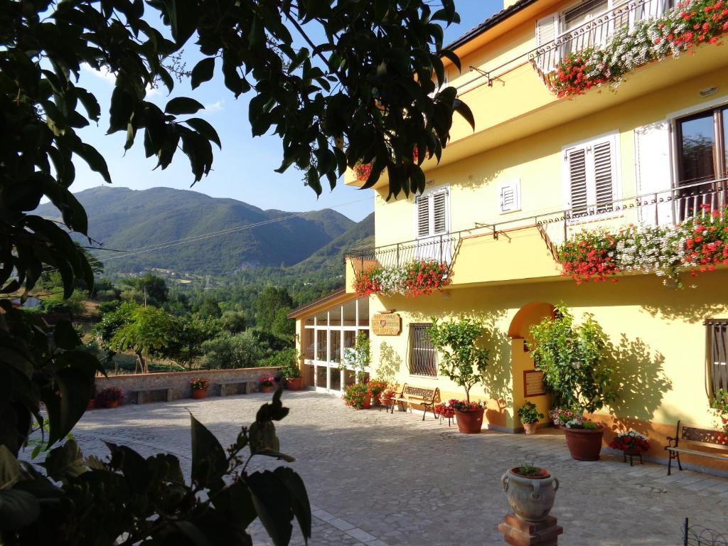 a view of a building with mountains in the background at B&B Cuoreverde Pollino in Rotonda