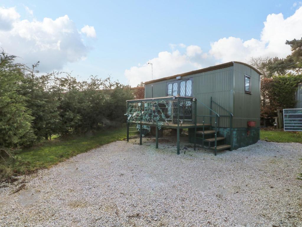 a tiny house sitting on top of a gravel lot at Packhorse Shepherds Hut in Belper