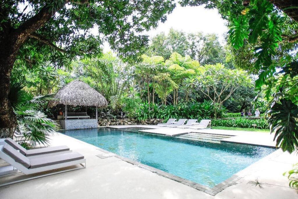 a swimming pool with lounge chairs and a resort at BoHo Home in Gated Eco Residence marAmar - Top location in Santa Teresa Beach